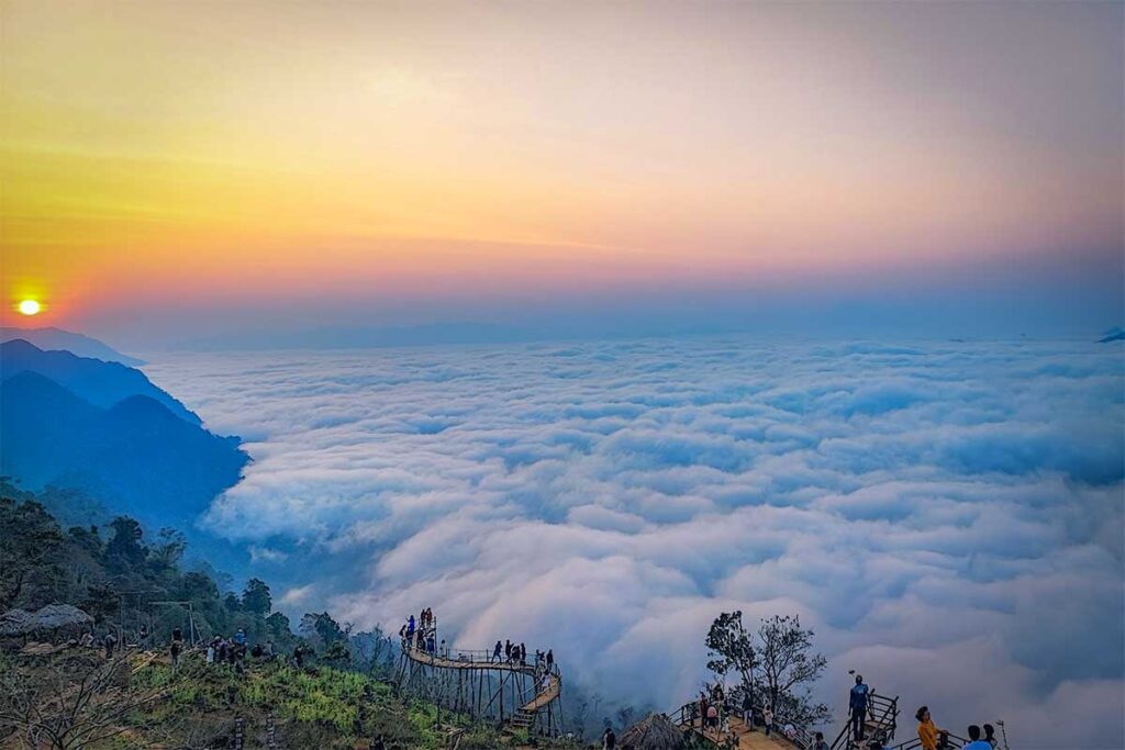 Thick cloud deck hanging between the mountains during sunrise seen from above at a viewpoint in Hang Kia - Mai Chau