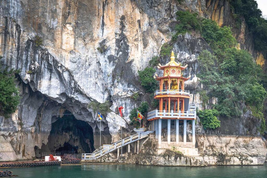 A cave with pagoda in a cliff part of Hoa Binh Lake