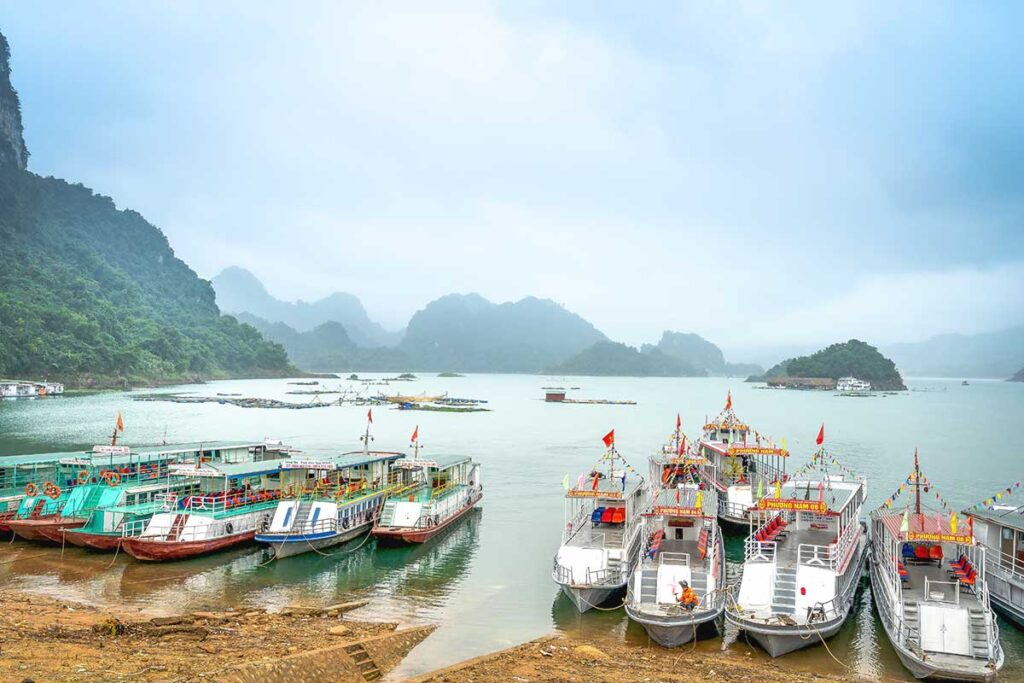 Boats docked on land at Hoa Binh Lake