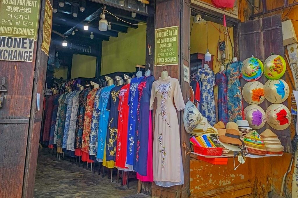 Ao Dai dress rental and souvenir shop in Hoi An selling colorful silk gowns and traditional Vietnamese hats, popular with travelers for photos and gifts.