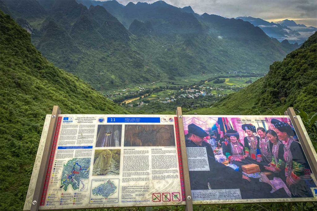 A information board about Lung Khuy Cave with on the background stunning mountain views