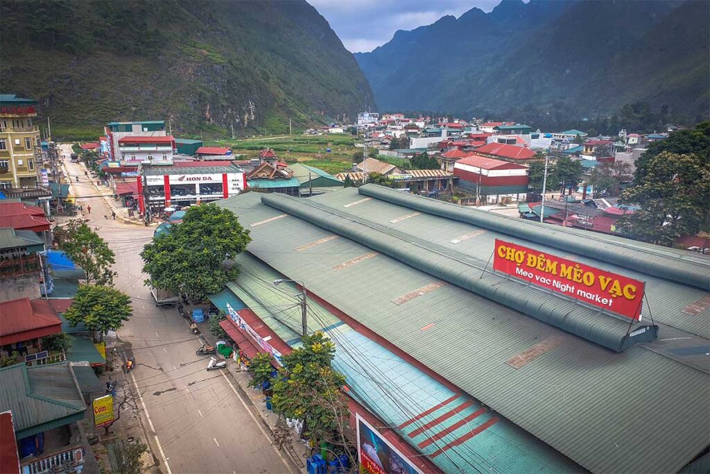 View of the streets of Meo Vac town with the local market building