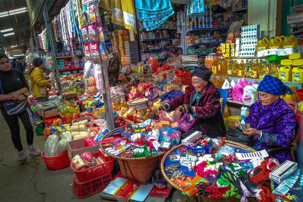Two local ethnic woman selling goods on the Muong Khuong Market