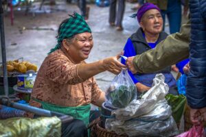 Ethnic minority woman selling vegetables at the Muong Khuong Market