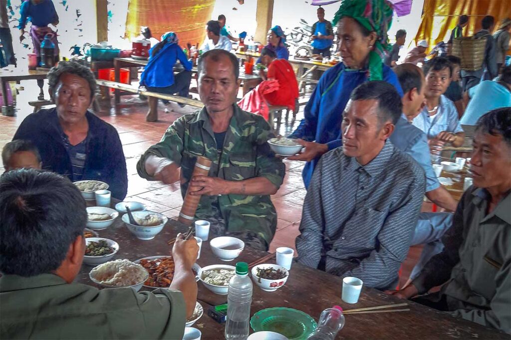 Local man eating food at the Muong Khuong Market