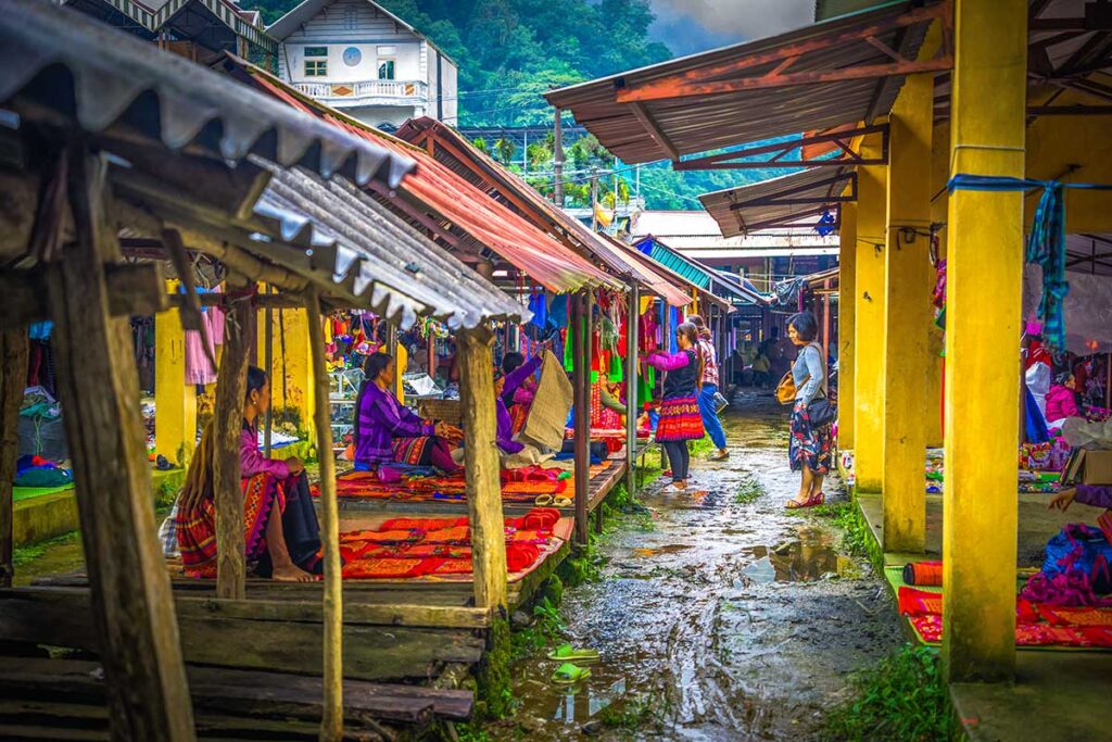 White Tay woman selling colorful clothes at Pa Co Market