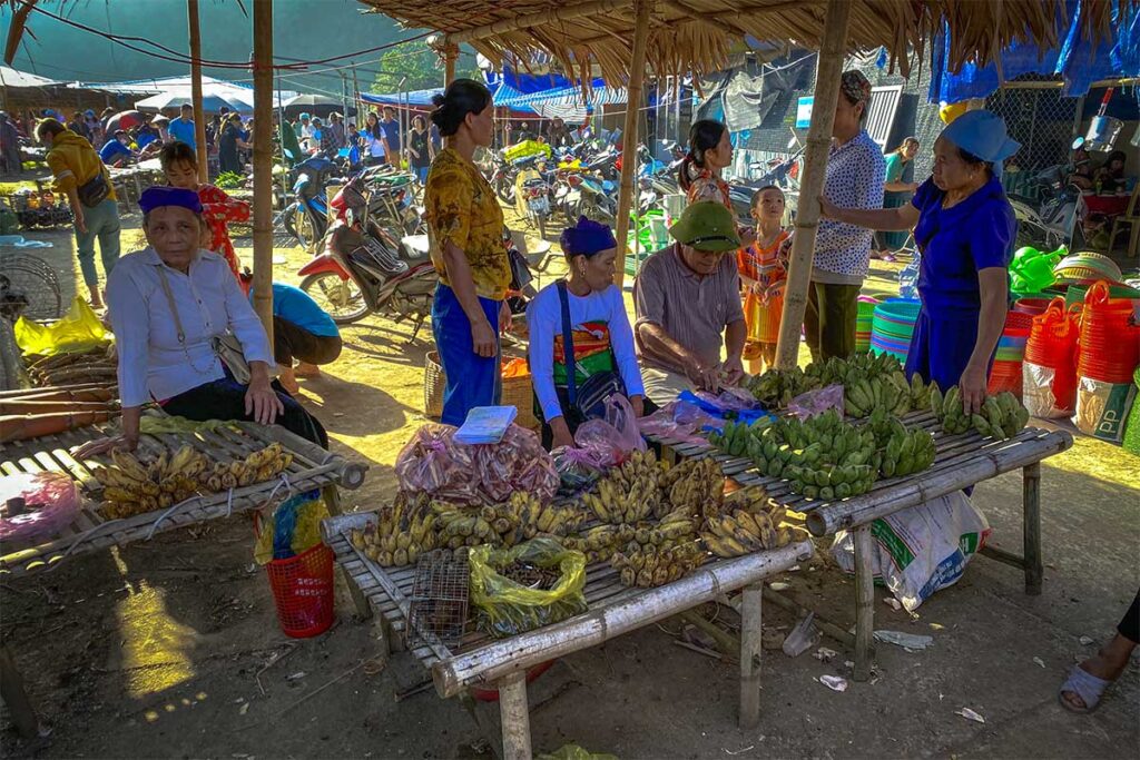 ethnic people are selling local produce at their market stalls on the Pho Doan Market