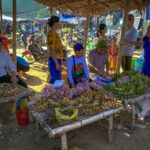 ethnic people are selling local produce at their market stalls on the Pho Doan Market