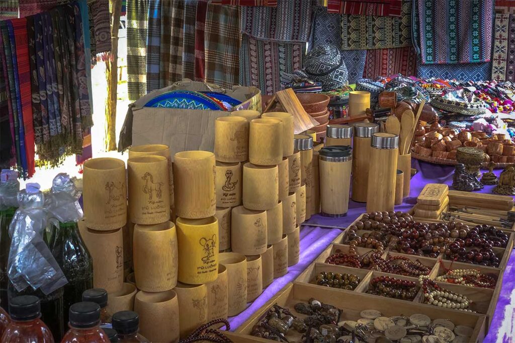 Handcrafted bracelets and drinking cups made of wood and bamboo sold as souvenirs at the Pho Doan Market