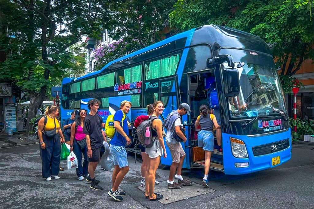 Backpackers lining up to get inside the sleeper bus to Ha Giang