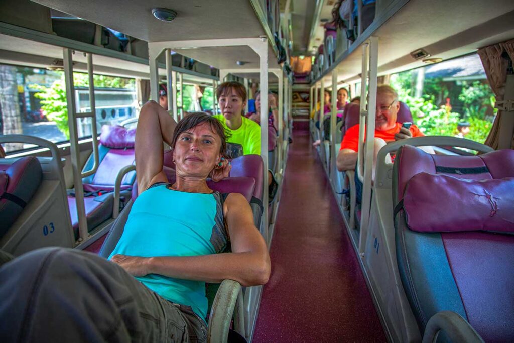 A traveller laying inside a standard sleeper bus in Vietnam