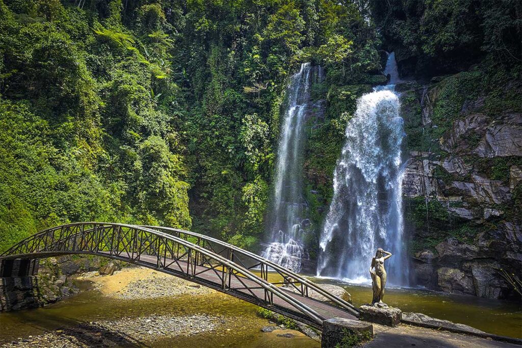 Thac Tien Waterfall in Xin Man, with a small stream and surrounded with jungle