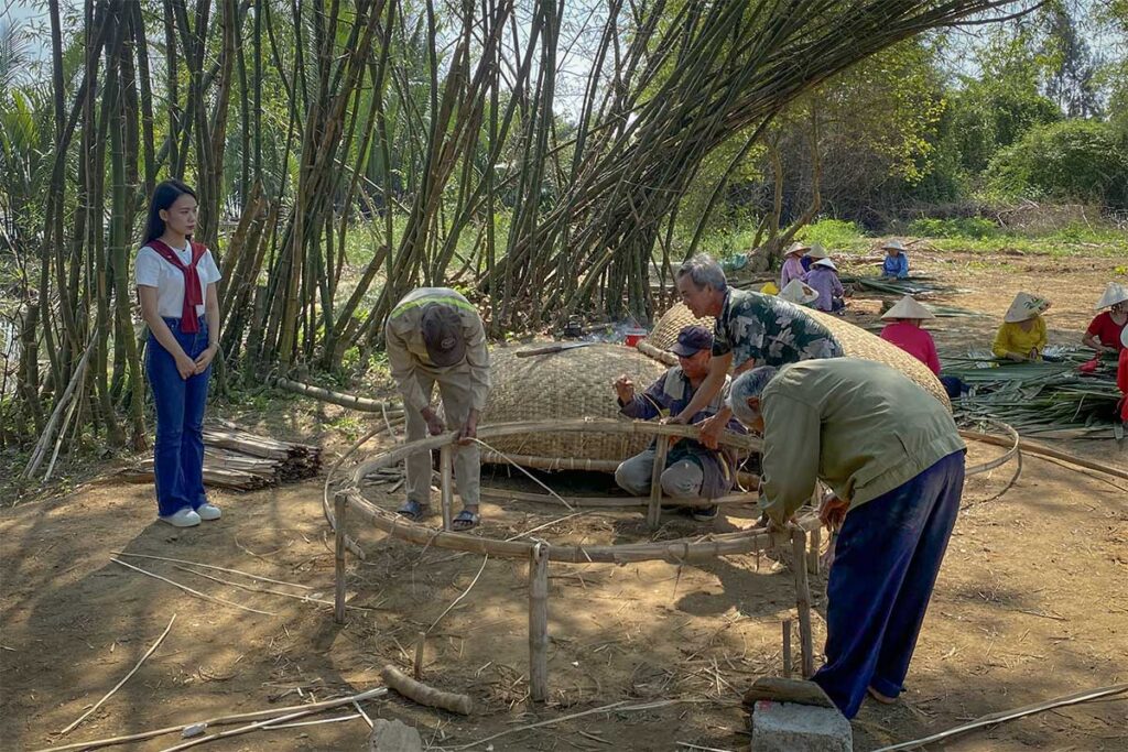 Fishermen building bamboo basket boats in Tra Nhieu Fishing Village – a traditional riverside community near Hoi An.