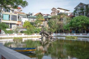 B-52 Lake in Hanoi with a crashed B-52 plane sticking out of the water of the lake which is surrounded by residential buildings