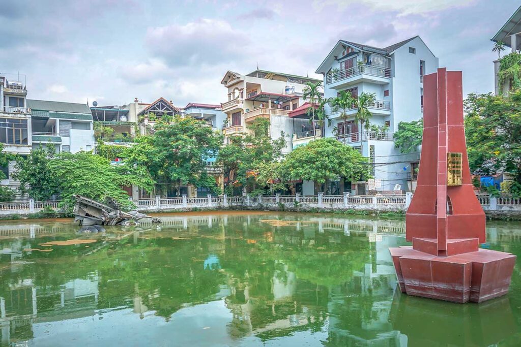 A small lake inside a local neighbourhood in Hanoi called Huu Tiep Lake - in the background in the lake, you see a small wreckage of a B-52 bomber plane giving the lake the nickname B-52 Lake