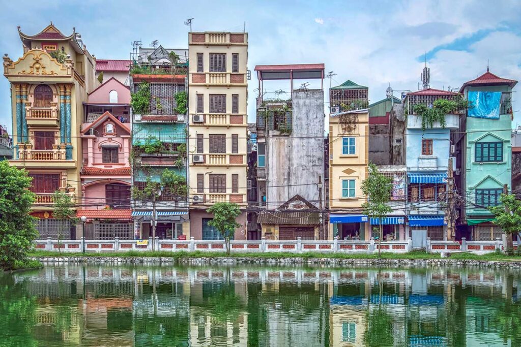 A typical local neighborhood of Hanoi with tube houses that reflect in a small like in front of it called Huu Tiep Lake - nicknames B-52 Lake