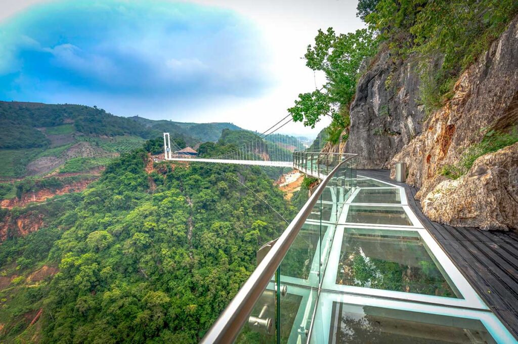 A glass walkway attached to cliffs part of Bach Long Glass Bridge complex in Moc Chau