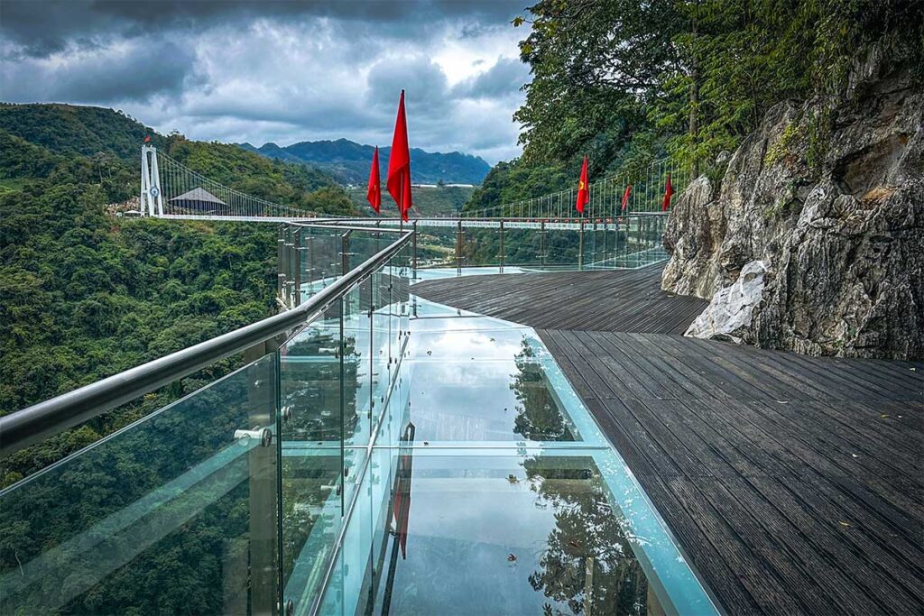 A glass walkway attached to cliffs part of Bach Long Glass Bridge complex in Moc Chau