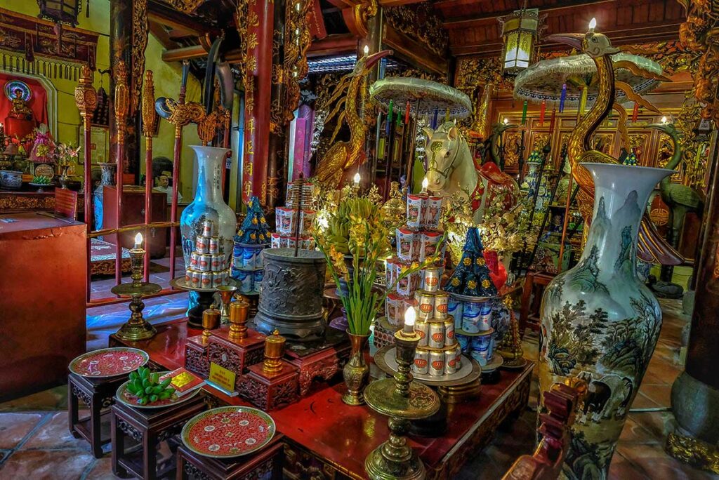 A statue of a white horse placed on an altar inside Bach Ma Temple in Hanoi
