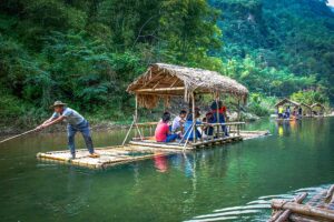 A bamboo raft floating over the Cham Stream in Pu Luong with domestic tourists