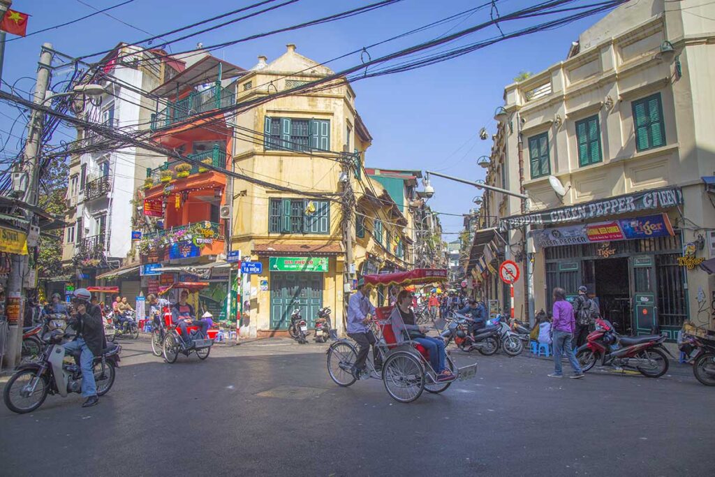 Ta Hien Street, also called Bia Hoi Junction, during the day with a cyclo passing through in Hanoi Old Quarter