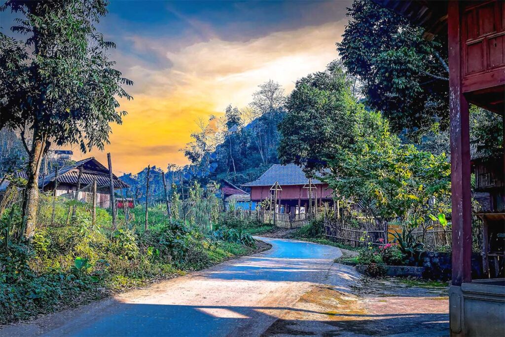 A countryside road through a rural commune of Chien Yen with stilt houses along the road