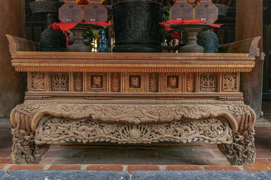 Detailed wooden carving of a altar inside But Thap Pagoda 