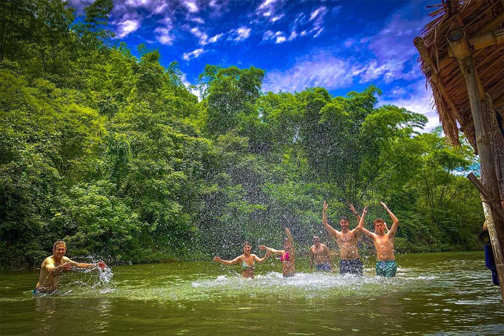 Foreign travellers swimming in the Cham Stream in Pu Luong