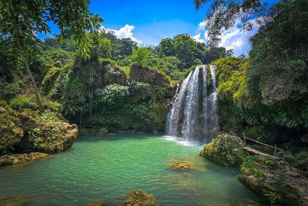 Chieng Khoa Waterfall - water plunging down in a natural pool surrounded by nature