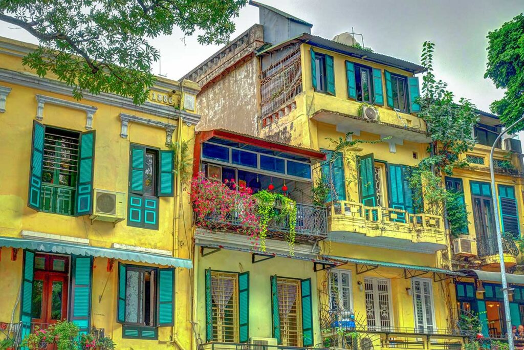 Old yellow buildings inside the French Quarter in Hanoi