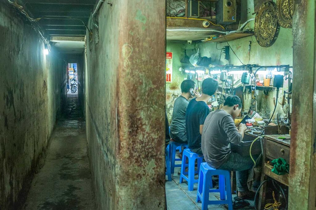 Seen from Hàng Bac Street, part alley and part a look into a small jewelry workshop where people are busy making jewelry 
