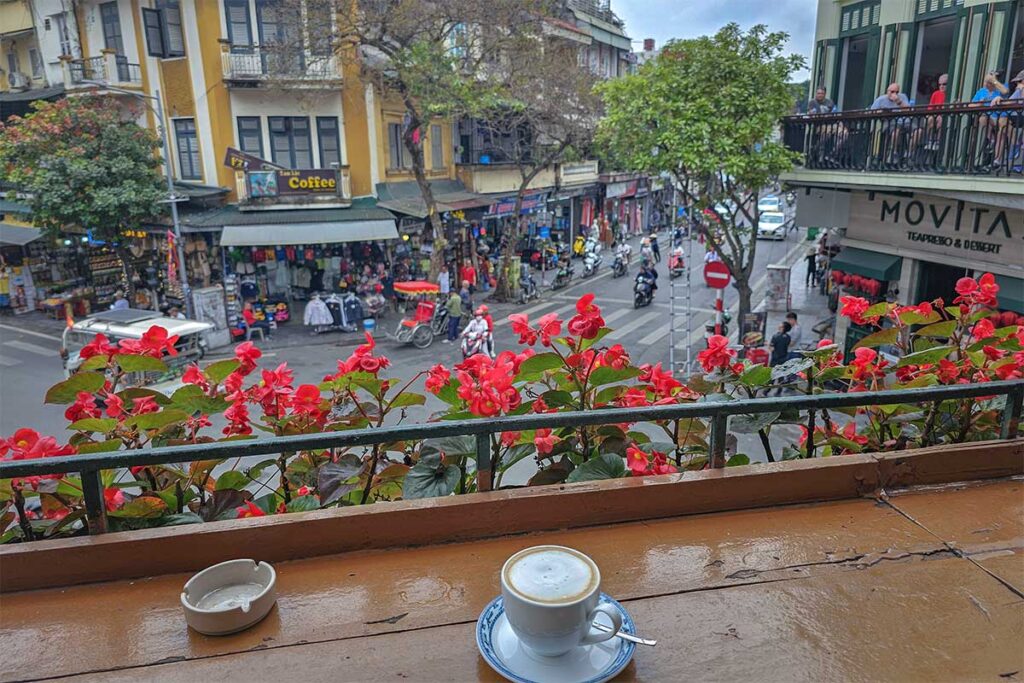 View from a balcony with a coffee overlooking Hang Dao Street in the Old Quarter