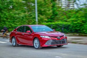 Renting car in Hanoi with driver - Toyota Vios driving through Hanoi streets with driver