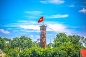 Closeup view of the top tower part and the Vietnamese flag of Hanoi Flag Tower