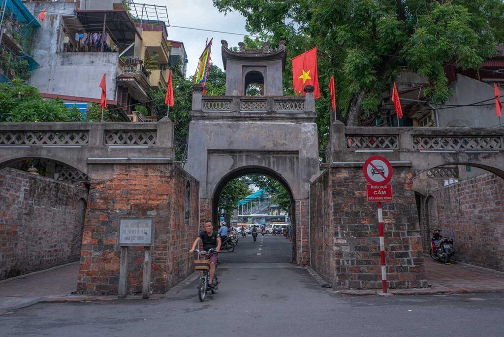 Hanoi Old City Gate (Quan Chuong Gate) - a cyclist just bikes through the gate into the Old Quarter