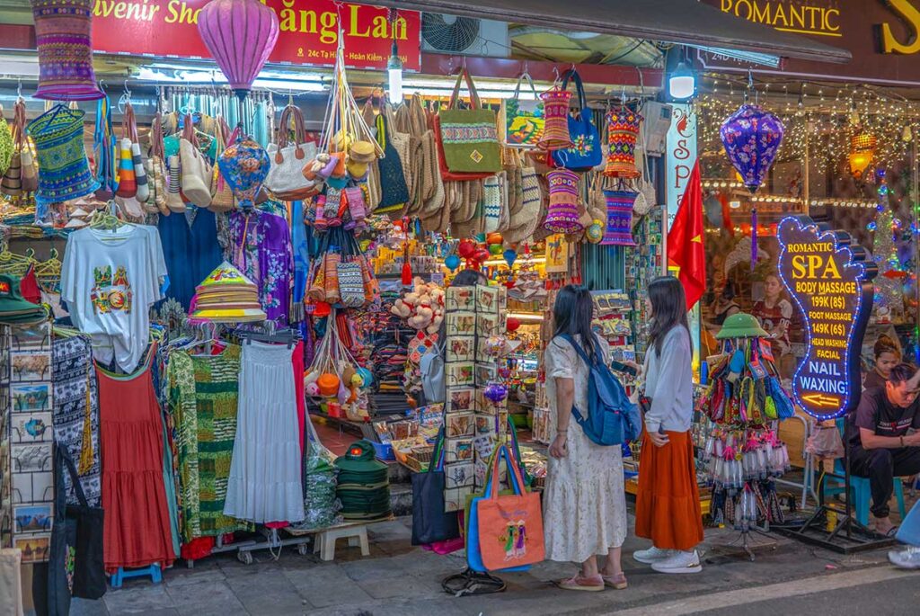 Two girls browsing and shopping at a local shop in Hanoi Old Quarter