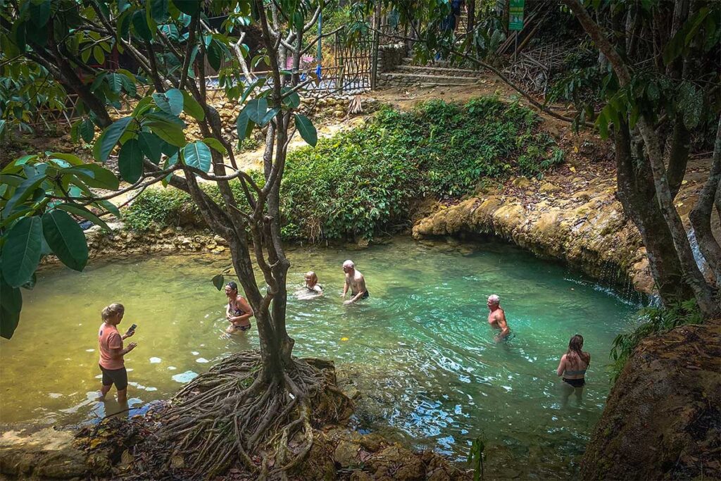 Tourist swimming in a natural pool of Hieu Waterfall in Pu Luong