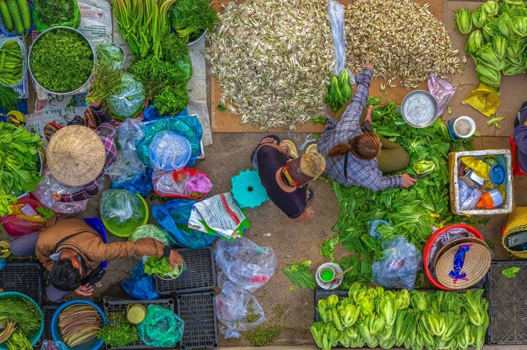 Seen from top, a local stall selling vegetables at the Hom Market