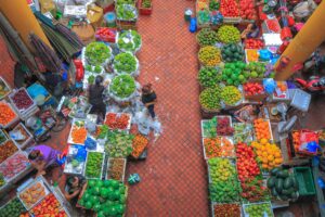 Vegetables laid out on the floor seen from the second floor looking down of the Hom Market in Hanoi