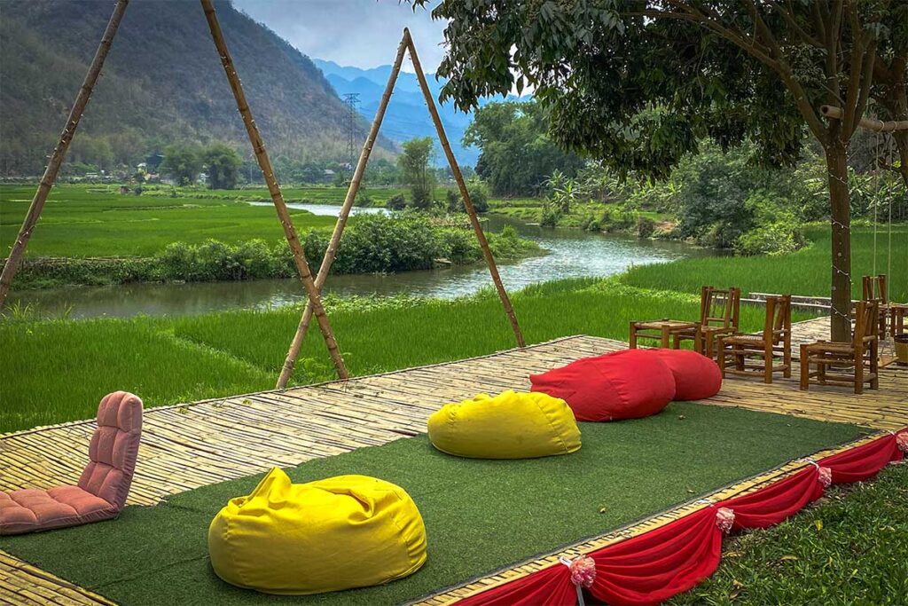 A small coffee shop along the river with bean bags serves as the Chieng Chau Kayak Pier in Mai Chau valley