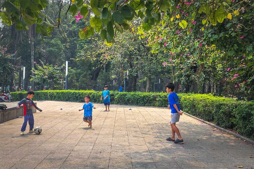 Kids playing football at Lenin Park in Hanoi 