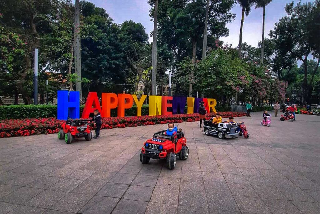 Young kids playing in small electric cars at Lenin Park in Hanoi
