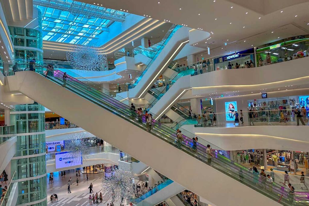 Huge hall with escalators and shops seen on different levels inside Lotte Mall West Lake Hanoi