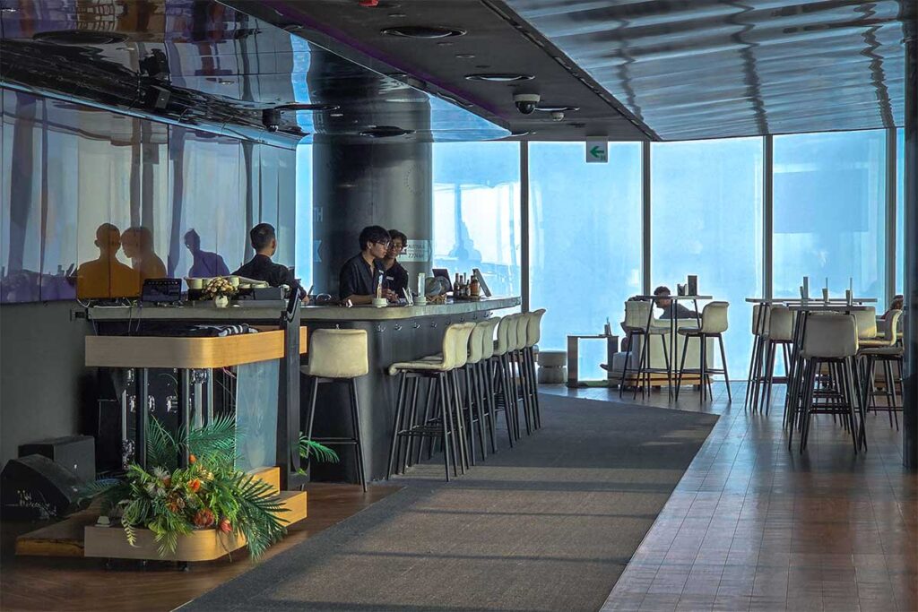 The rooftop bar called Top of Hanoi with large windows overlooking Hanoi