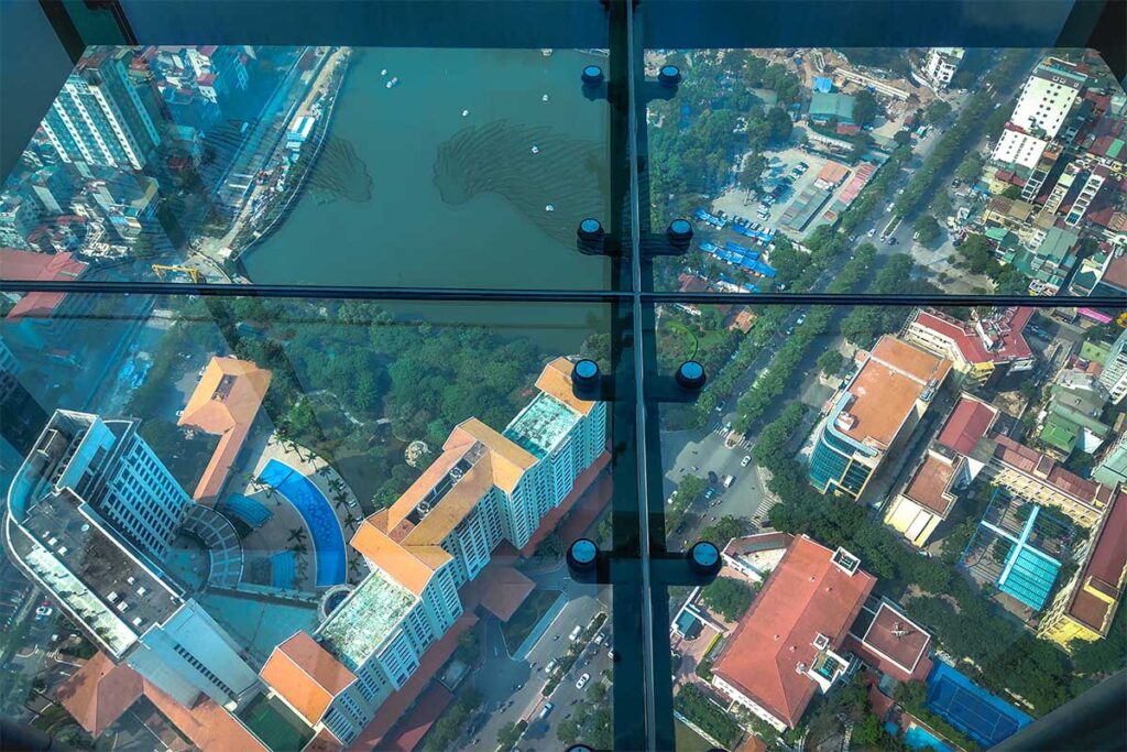 Looking through the glass floor with the streets and houses far below seen from Lotte Observation Deck