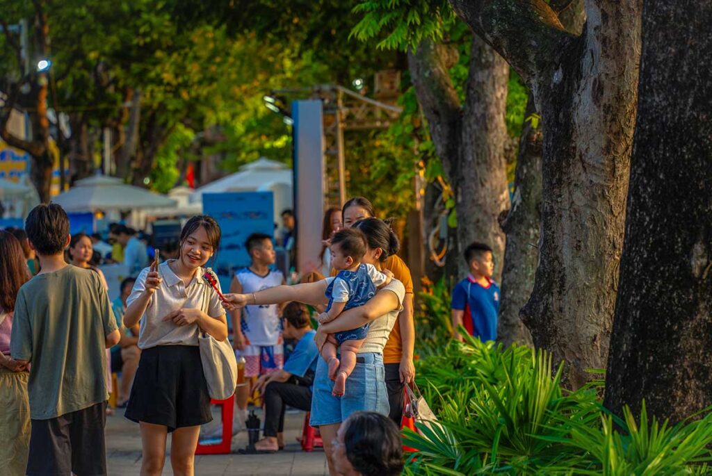 Locals of Hanoi chatting underneath the trees of Ly Thai To Park