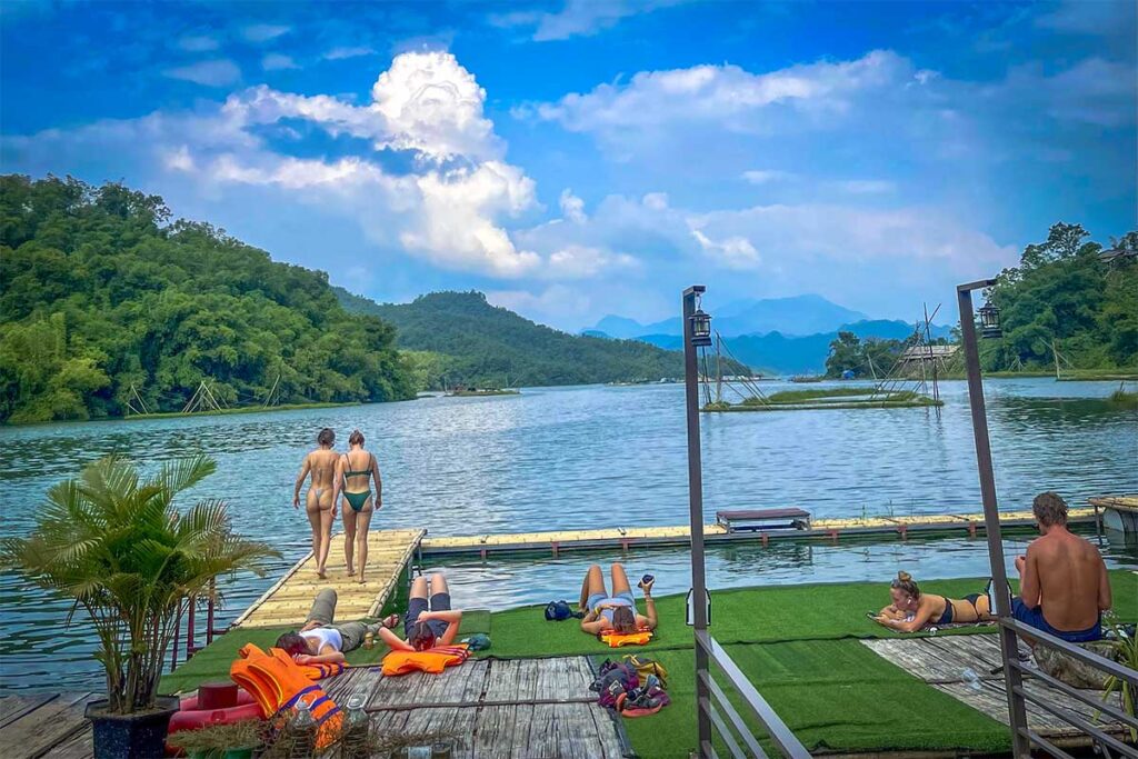 People swimming and sunbathing at Mai Chau Floating House