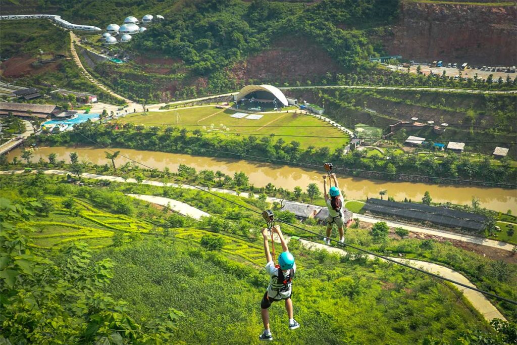 Two people zip lining at Moc Chau Island near the Vietnam's Glass Bridge