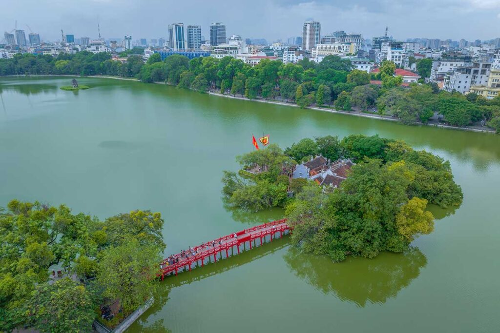 Aerial view of Ngoc Son Temple (Jade Mountain Temple) and the red Huc Bridge in Hoan Kiem Lake
