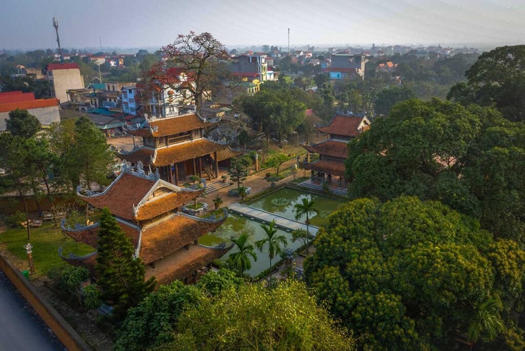 Aerial view over Nom Pagoda and small pond and Nom Village